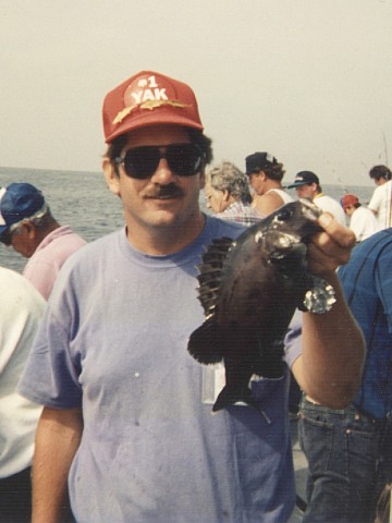 Peter holding a foot-long giant sea bass