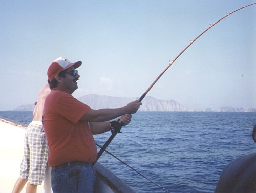 Peter holding a bent rod with Anacap in the background