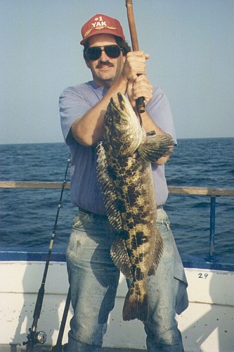 Peter holding a 15-pound lingcod on a gaff