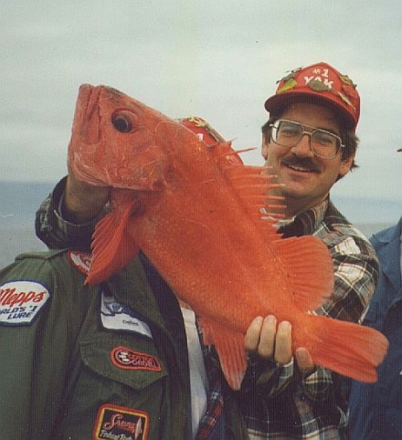 Peter holding a bright red rockfish