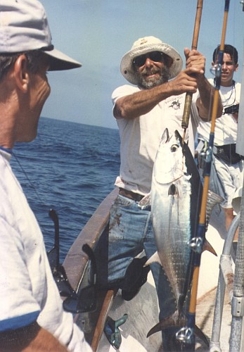 holding a nose-gaffed 30 lb bluefin